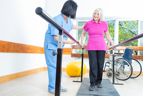 Nurse helping a patient with balance therapy