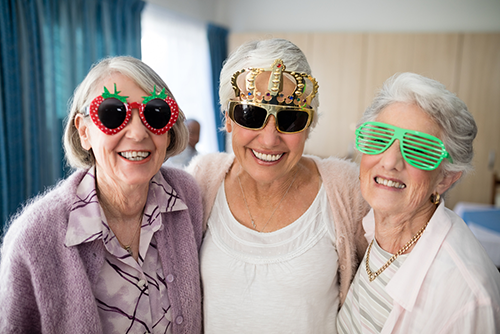 Group of elderly women in festive sunglasses